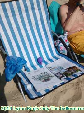  lymejuly 2019 Lyme Regis July The balloon reading on the beach